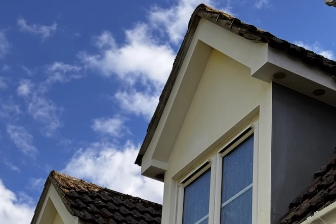Cleaned render around a dormer window at a home in Chippenham, Wiltshire