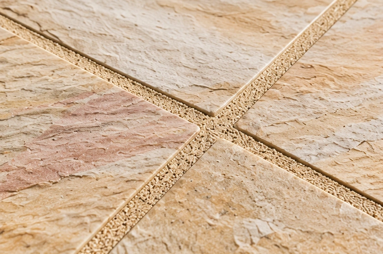 Neutral buff patio jointing with warm sandstone paving