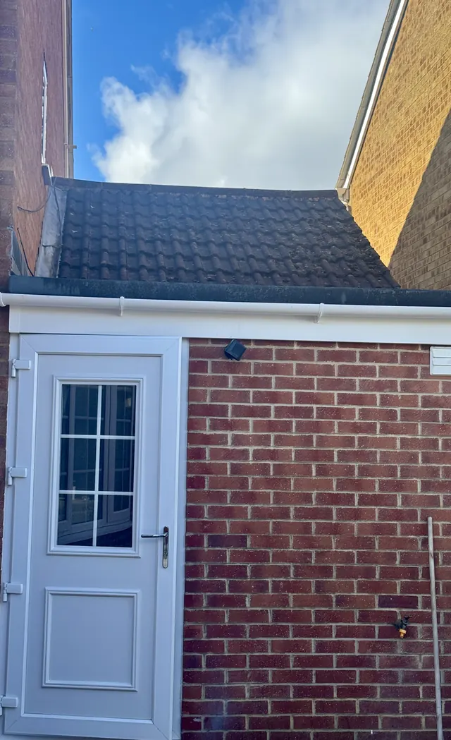Extension roof with dark, moss-stained tiles before cleaning, Jetstream Powerwash Swindon