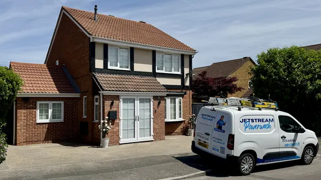 Detached house with a freshly cleaned tiled roof and a Jetstream Powerwash van parked outside