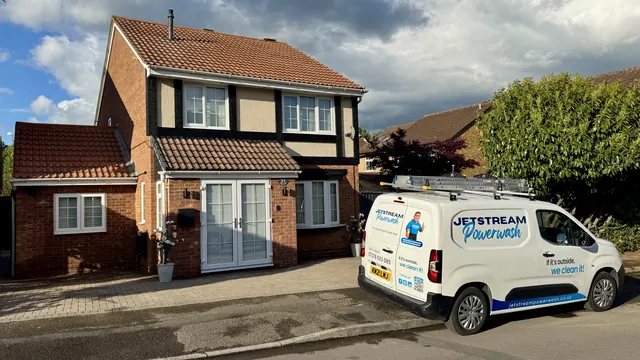 The same home after roof cleaning, with a clean roof and a Jetstream Powerwash van outside