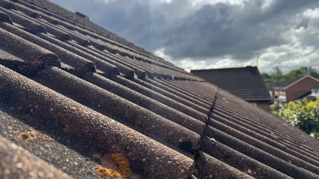 Detail of a cleaned concrete roof tile surface and ridge
