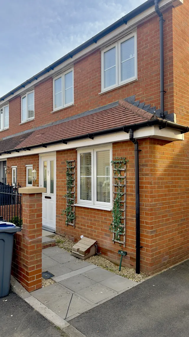 The same brick house in Royal Wootton Bassett after cleaning, with a cleaner roof