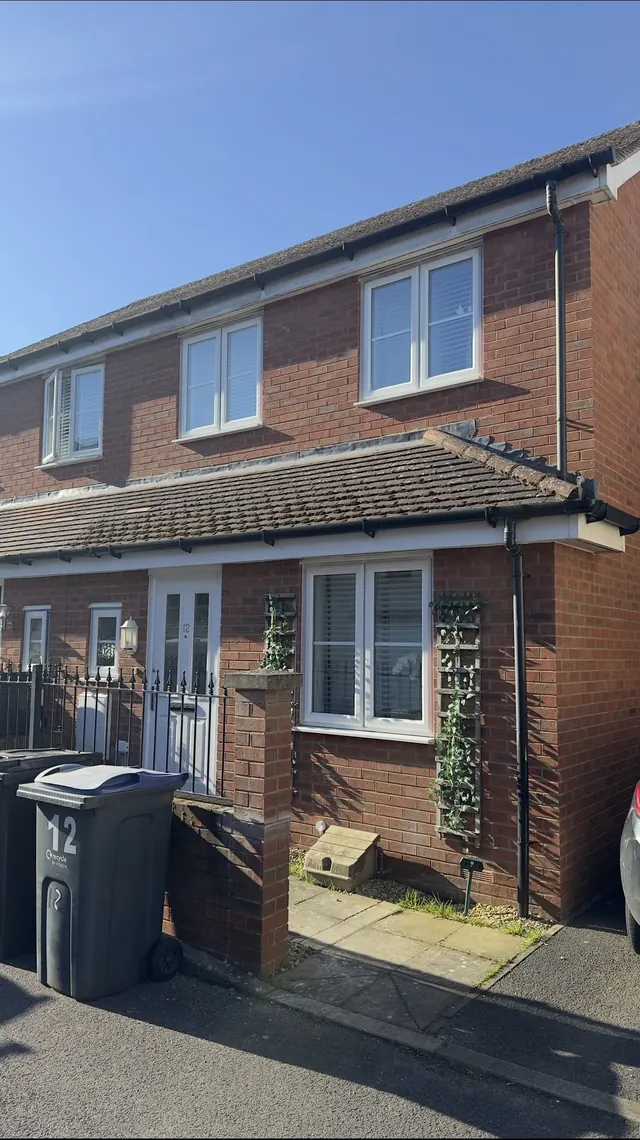 Brick house in Royal Wootton Bassett with a dull, weathered porch roof before cleaning, Jetstream Powerwash Swindon